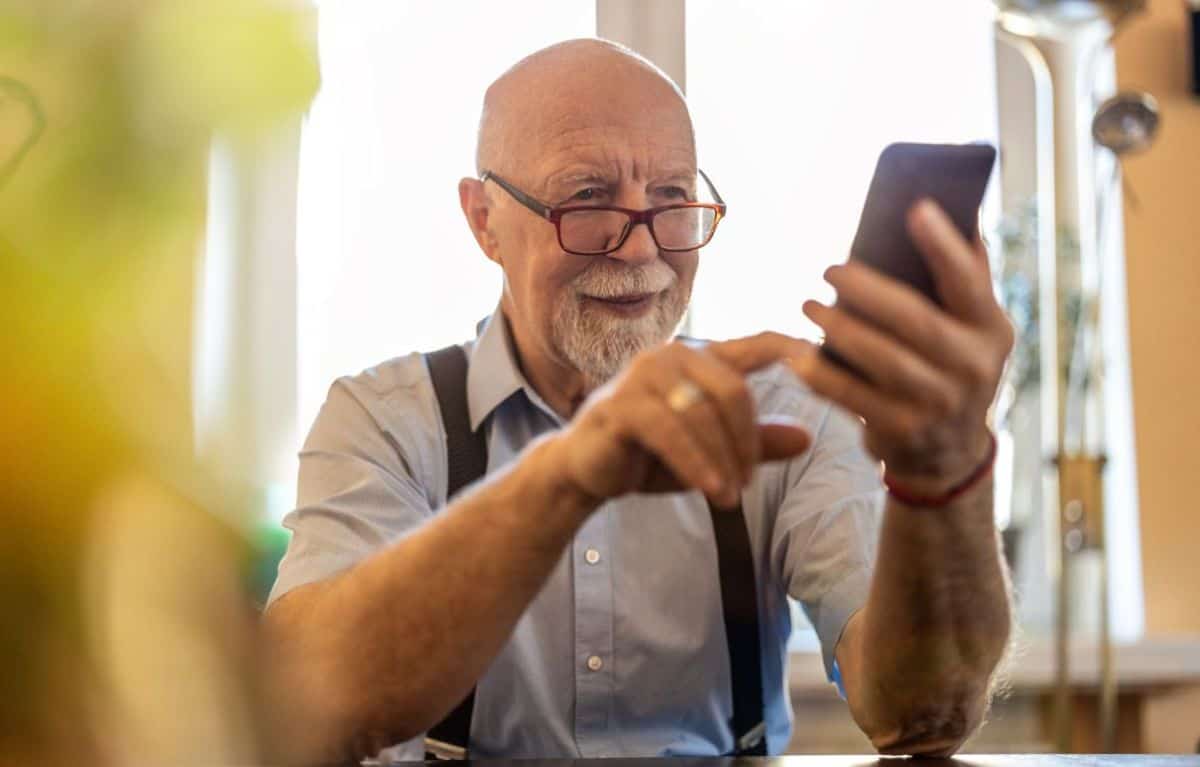 A senior man using a smart phone