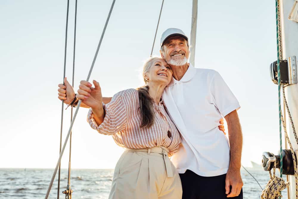 A senior man and a senior woman sailing on a boat