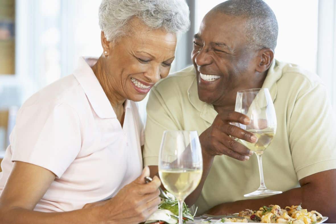 man and woman drinking white wine at dinner