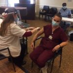 A health care professional getting the covid vaccine