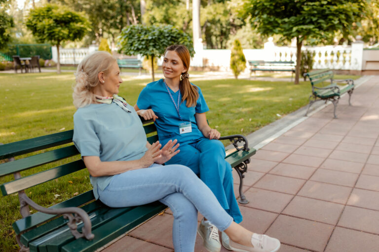 Healthcare, Retirement and a Nurse Talking to an Old Woman Outdoor of a Nursing Home. Medical, Trust and Care With a Female Medicine Professional Chatting to a Senior Resident