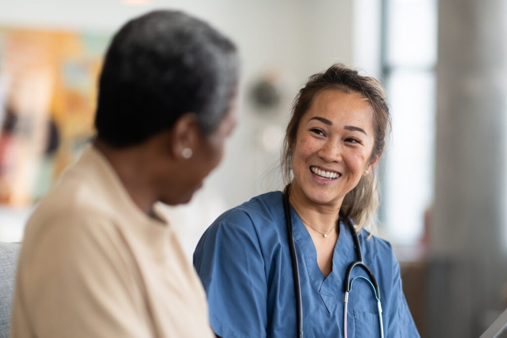 nurse smiling at senior woman