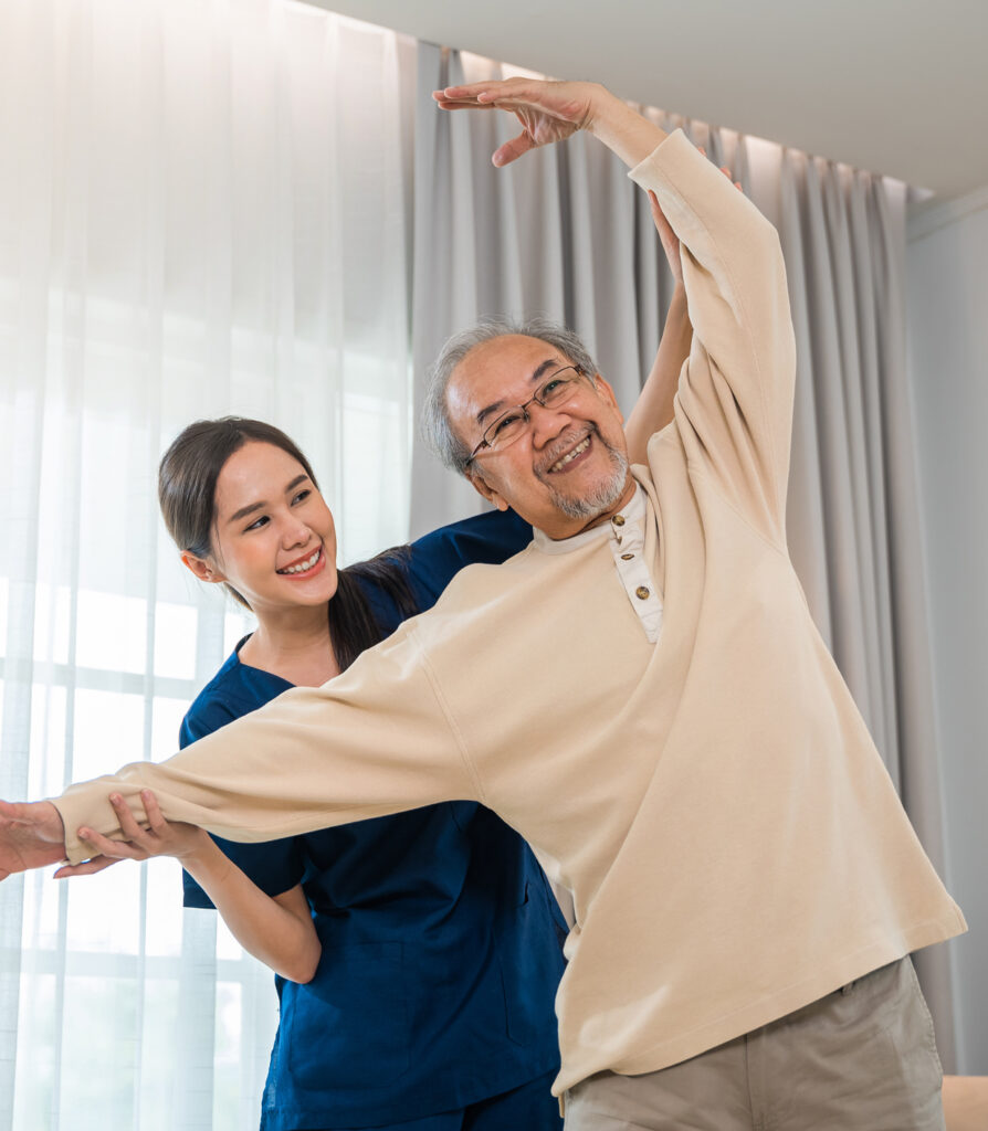 Old senior man enjoys training with physiotherapist for outstretched arms at home, Asian physical therapist patient nursing helping elderly exercising arm stretch, Rehabilitation of disabled concept