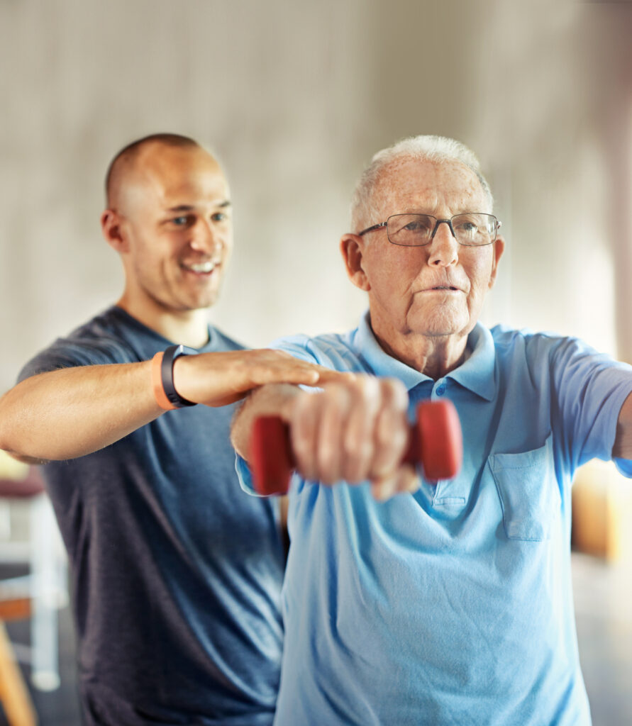 Shot of a senior man working out with the help of a trainer