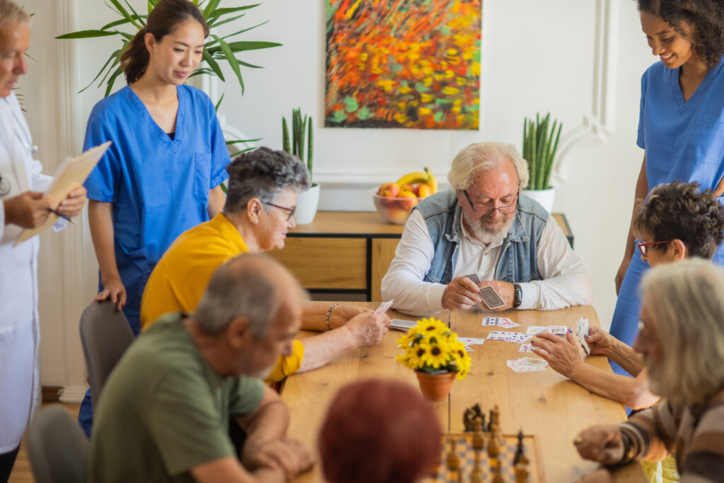 Happy senior people playing card at nursing home