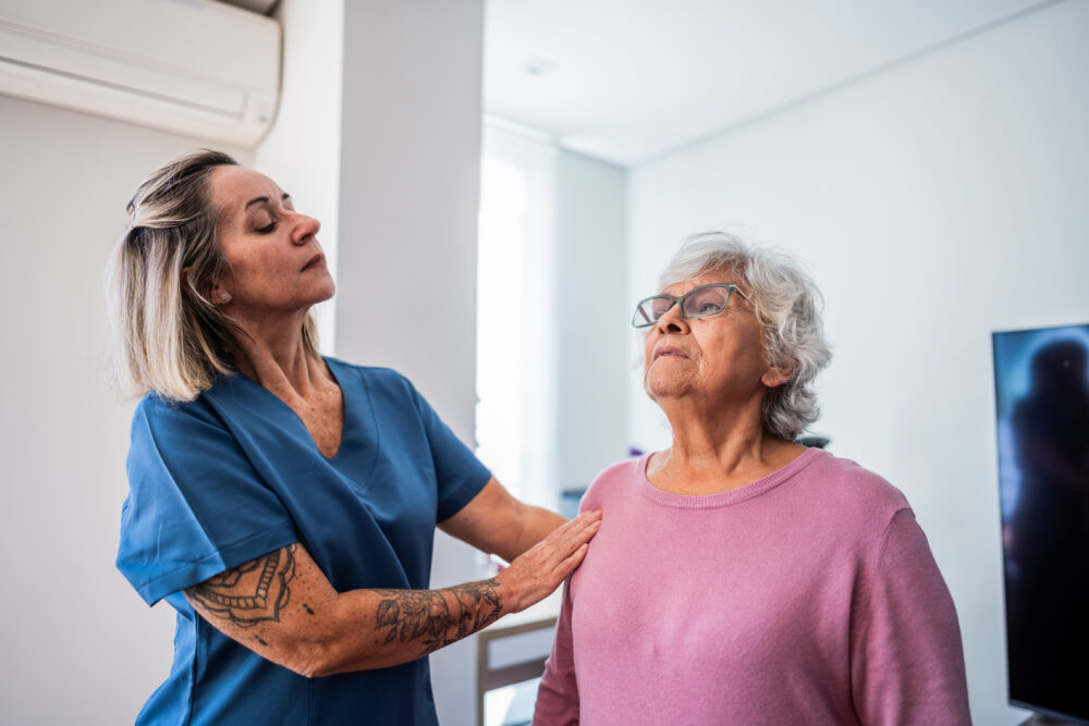 Nurse doing postural exercises with senior woman