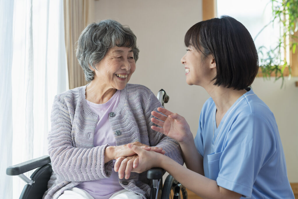 Female health care workers and senior women in wheelchairs.