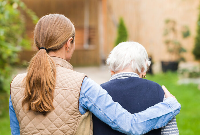 Granddaughter and grandmother walking outside together