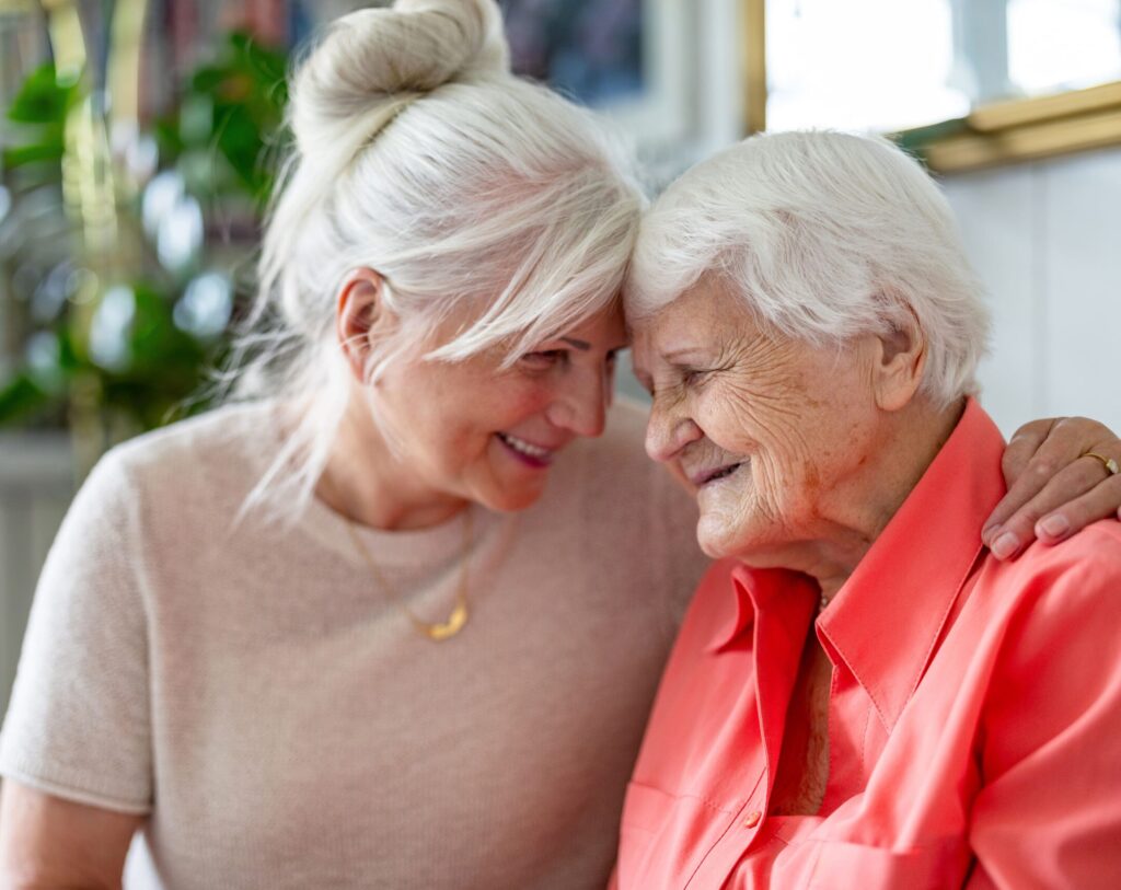 senior woman and daughter touching heads