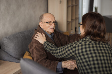 Woman visiting elderly man at a nursing home