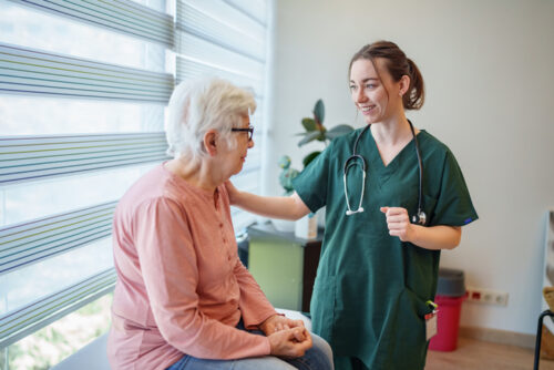 Doctor Providing Comforting Reassurance to Elderly Patient Through Touch During Medical Appointment