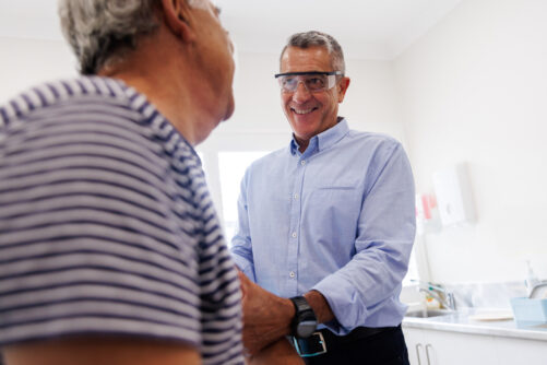 Australian man receiving flu shot from his doctor